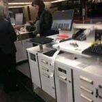 Airport ticket counter with agents assisting passengers late at night.