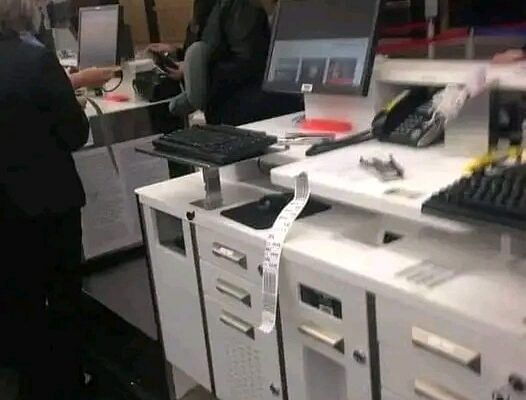 Airport ticket counter with agents assisting passengers late at night.