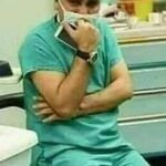 Surgeon in distress and a newborn lying on a mother who passed away during childbirth.