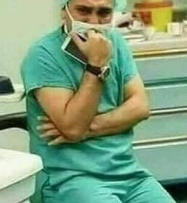 Surgeon in distress and a newborn lying on a mother who passed away during childbirth.
